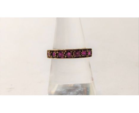 A 9 carat gold seven stone ruby ring, finger size M, 2.4 g gross