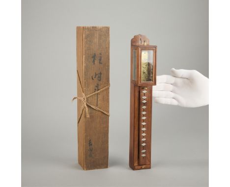 A fine Japanese Shaku Dokei pillar clock. Shitan wood case with glaze canopy. The movement with balance wheel and engraved fr