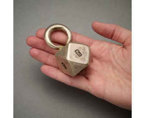 Counter balance back ornament from the Dong culture of Guizhou. In the form of a 14 sided die with a large loop. Stamped on f