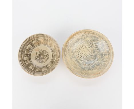 Group of two Thai Sukhothai stoneware bowls, ca. 14th-16th c. One with a fish motif and one with a floral motif.Loan: Minneap