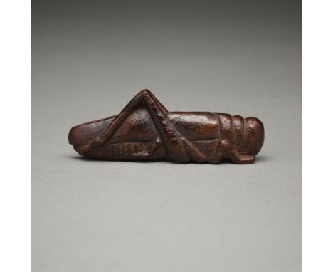 Antique Japanese carved wooden netsuke in the form of a grasshopper.Height: 1 in x width: 3 in x depth: 1/2 in.Condition: The