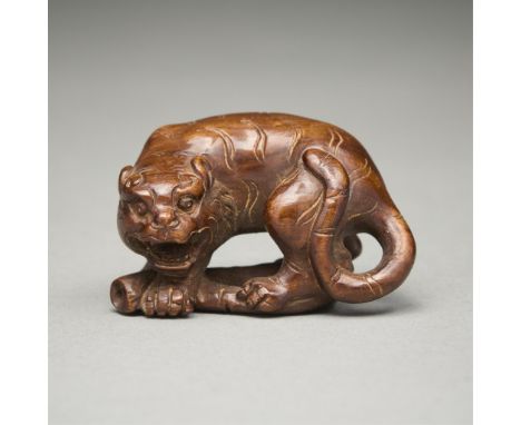 Antique carved wood netsuke in the form of a tiger atop a piece of bamboo. Signed along the back of the tiger. With a wooden 