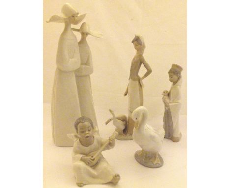 Four Lladro figurines and one Nao example 