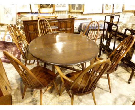 Ercol dining suite comprising drop leaf dining table with six matching dining chairs including two carvers and a matching sid