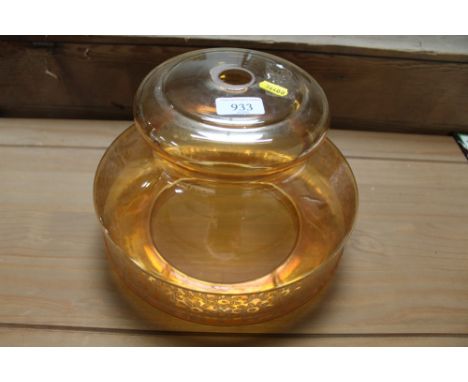 An amber coloured glass light shade