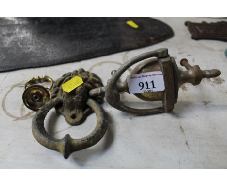 A lion mask decorated door knocker and one other