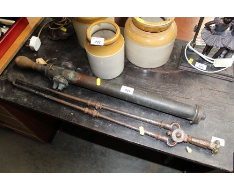 A vintage garden sprayer together with a pair of fire tongs