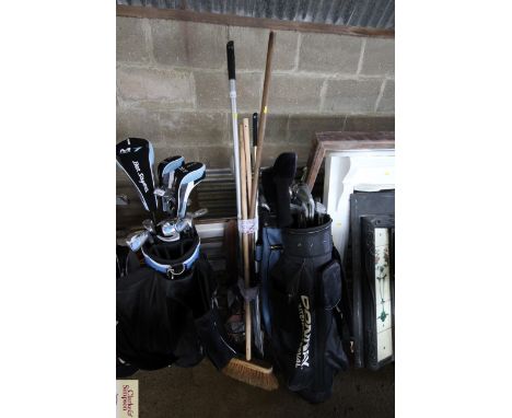 A quantity of long handled tools to include broom, rakes, spades etc.