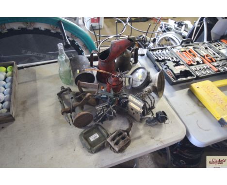 A quantity of vintage items to include oil cans, blow torches, pulleys, head lamps, glass bottles etc.