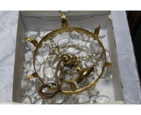 A brass and glass hanging light fitting decorated with glass prism drops 