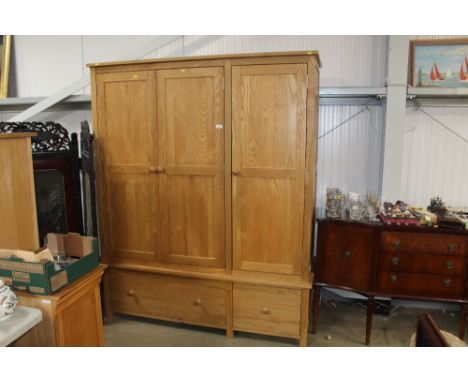 An oak triple wardrobe fitted two drawers