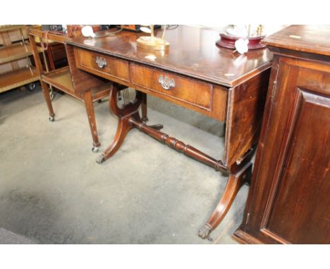 A mahogany sofa table fitted two drawers together with an oak tea trolley