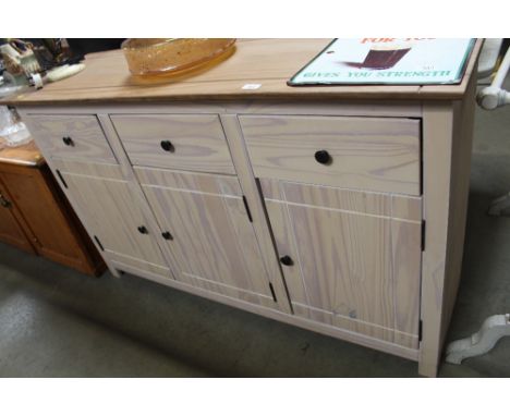 A pine sideboard fitted three drawers