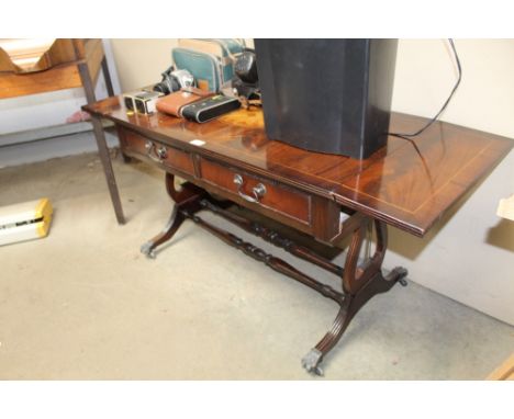 A sofa table fitted two drawers raised on stretcher base