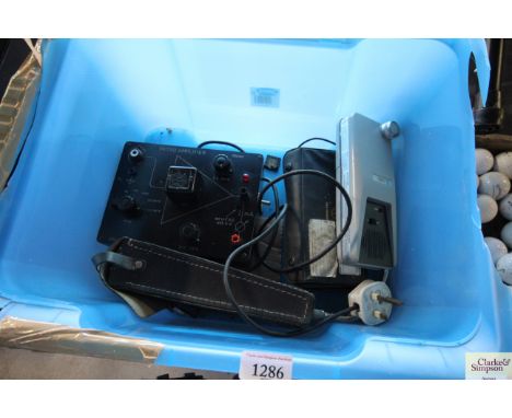 A plastic box containing a micro amplifier, a halogen leak detector etc.