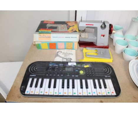 A Casio keyboard together with a child's Volcan sewing machine with original box and instruction manual
