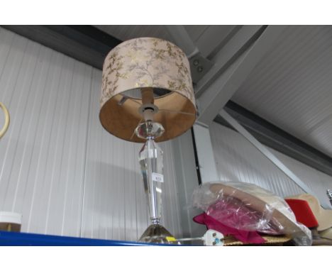 A glass table lamp and shade