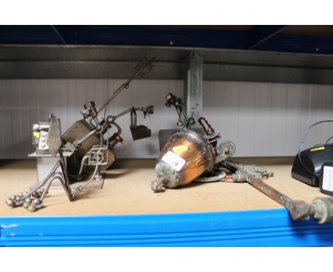 A hanging light fitting and four metal sculptures