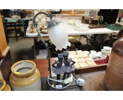 A figural decorated table lamp