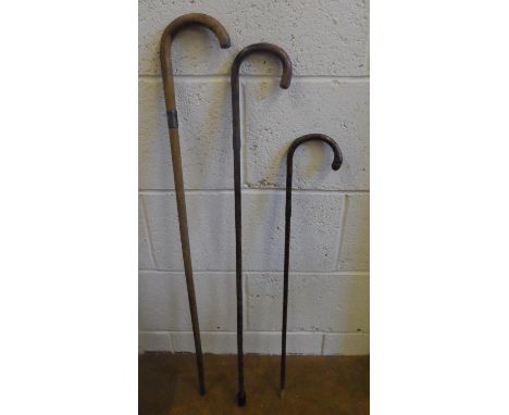 Three antique sticks, all with small silver bands, 2 are walking sticks the other a swagger stick (3) 