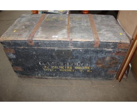 A wooden and metal lined chest containing various tools