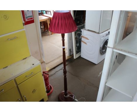 A mahogany standard lamp and shade 