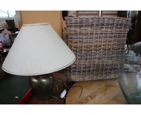 A table lamp ad shade and a wicker basket with metal lining 