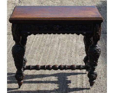 A Victorian carved oak card table. 91 cm wide.