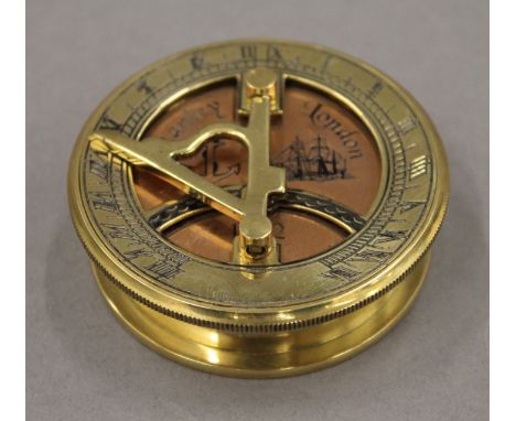 A brass and copper sundial compass. 6.5 cm diameter.