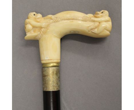 A walking stick with a carved bone handle formed as monkeys. 91.5 cm high.