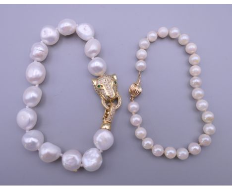 A pearl bracelet with a 14 K gold clasp and a pearl bracelet with a panther formed clasp. 