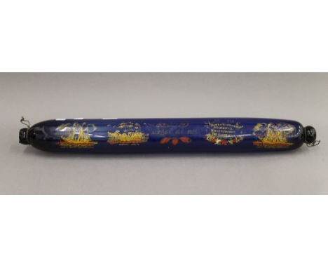 A large Victorian blue glass rolling pin, painted with various ships and verses. 77 cm long.