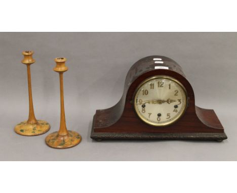 A pair of penwork candlesticks and a mantle clock. The former each 25.5 cm high.