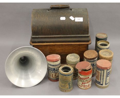 A Thomas A Edison oak cased phonograph with horn; together with a selection of phonograph rolls. 32.5 cm wide.