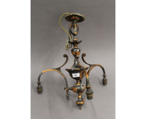 A copper chandelier with three glass shades. 45 cm high.