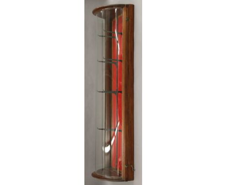 A bow fronted display case. 109 cm high.