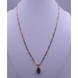 A 9 K gold chain set with diamond and sapphire pendant. 7.9 grammes total weight.