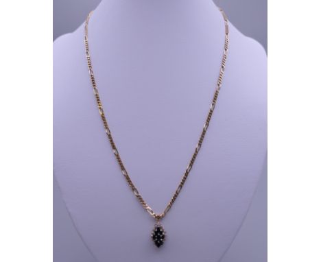 A 9 K gold chain set with diamond and sapphire pendant. 7.9 grammes total weight.