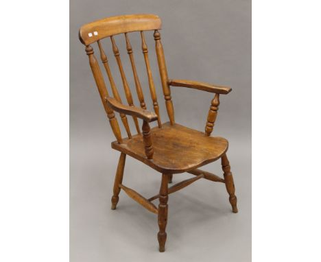 A Victorian elm seated stick back armchair. 56.5 cm wide.