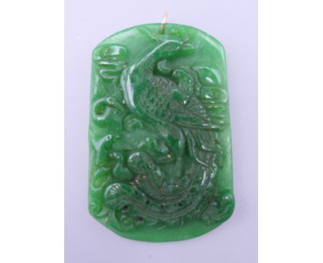 A gold mounted carved apple green jade pendant. 6.5 cm high.