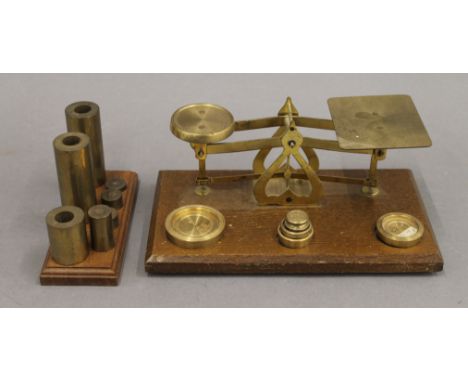 A small set of brass scales and various weights. Scales 20 cm wide.