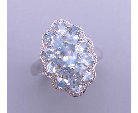 A silver aqua cluster ring. Ring size P.