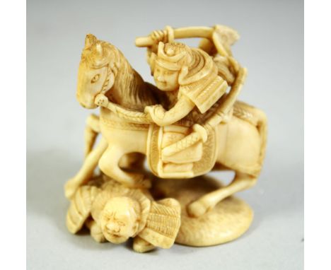 A JAPANESE CARVED IVORY NETSUKE, of a warrior on horseback, with another figure at his side and a trampled figure beneath the