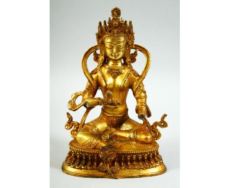 A GILT BRONZE MODEL OF A SEATED DEITY, 22.5cm high.
