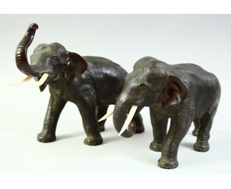 A SUPERB PAIR OF JAPANESE BRONZE ELEPHANTS, with carved ivory tusks, each with impressed seal mark to the underside, 29cm and