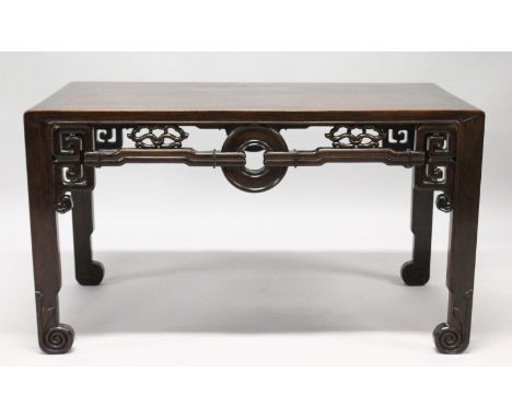 A VERY GOOD CHINESE RECTANGULAR LOW TABLE, POSSIBLY HUANGHUALI, with well carved pierced frieze, on four flattened legs with 