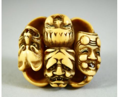 A JAPANESE CARVED IVORY NETSUKE, carved as a roundel of noh masks, discreetly signed inside, 4cm.