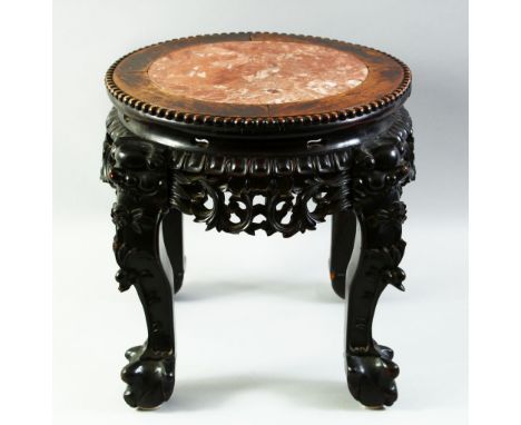 A CHINESE CARVED HARDWOOD AND MARBLE INSET STAND, with pierced frieze and supported on four carved legs with claw form feet, 
