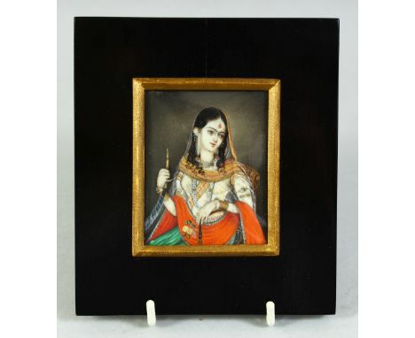 AN INDIAN MINIATURE FEMALE PORTRAIT ON IVORY, painted with gilt highlights and encased within an ebonised wooden frame and gl