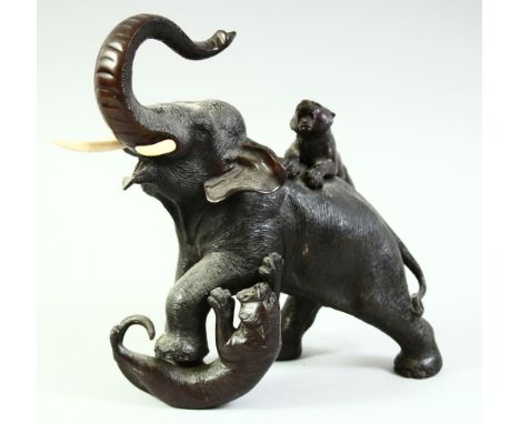 A JAPANESE MEIJI PERIOD BRONZE GROUP OF A BULL ELEPHANT being attached  by two tigers, with impressed seal mark to base, 20cm